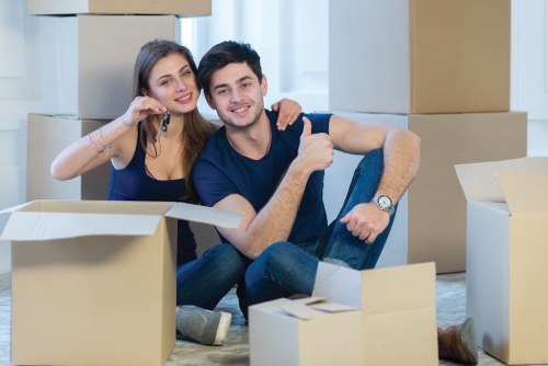 Student moving boxes and furniture in an Islington residential street