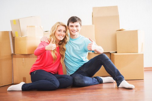 Moving team handling boxes and furniture near Islington apartments