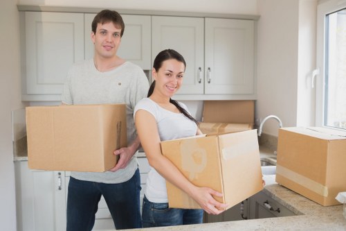 Professional movers handling desks and IT equipment during an office move